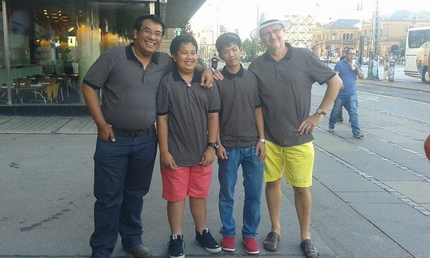 Two families ran into each on vacation all wearing the same shirt. There