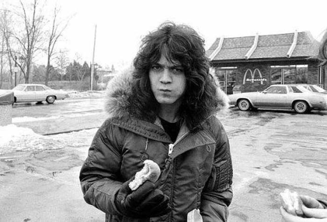 Eddie Van Halen munching on a burger.