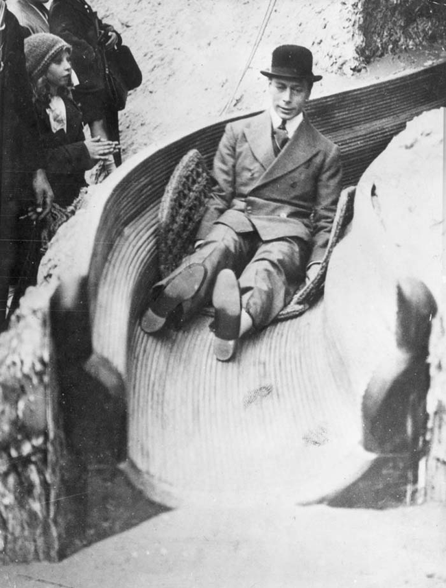 King George VI of England enjoys himself on a slide.